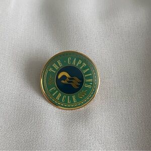 The Captain’s Circle Pin – Gold Emblem of Prestige with Nautical Flair